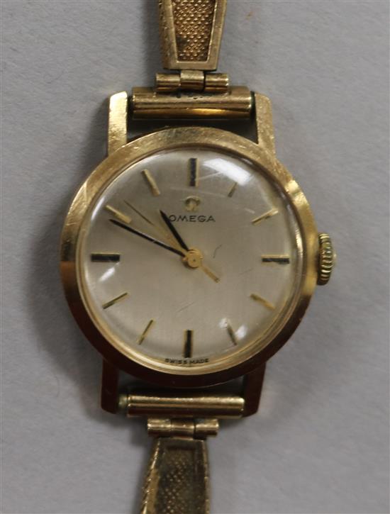 A ladys 9ct gold Omega manual wind wrist watch, on 9ct gold bracelet.